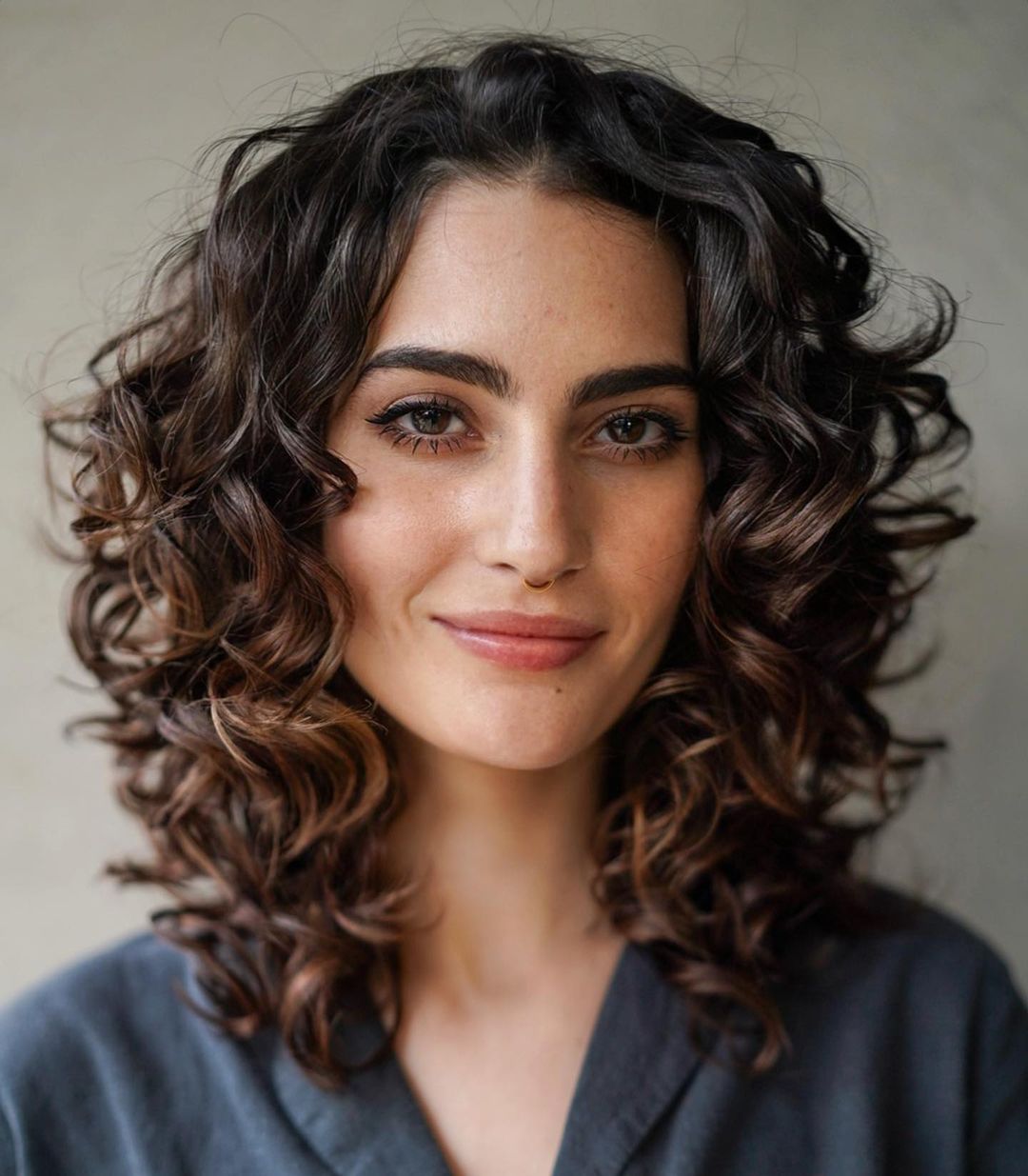 Shoulder-Length Curly Hair With Curtain Bangs